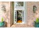 Inviting front entrance with brickwork, lanterns, and decorative planters at 255 Emerald Lake Dr, Fayetteville, GA 30215