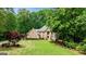 Charming two-story brick house surrounded by a lush, green landscape at 255 Emerald Lake Dr, Fayetteville, GA 30215