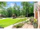 Beautiful manicured front yard featuring mature landscaping and brick walkway at 255 Emerald Lake Dr, Fayetteville, GA 30215