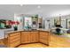 Open kitchen layout with a wooden island, granite countertops, and seamless flow to an office space at 255 Emerald Lake Dr, Fayetteville, GA 30215