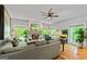 Bright living room with hardwood floors, a ceiling fan, and a lovely brick fireplace at 255 Emerald Lake Dr, Fayetteville, GA 30215