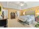 Spacious main bedroom with a tray ceiling, bench, and a large tufted headboard at 255 Emerald Lake Dr, Fayetteville, GA 30215