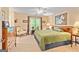 Spacious main bedroom featuring a large bed, ceiling fan, and natural light from the window at 255 Emerald Lake Dr, Fayetteville, GA 30215