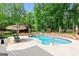 Refreshing pool with ample seating, lush landscaping, and mature trees for shade at 255 Emerald Lake Dr, Fayetteville, GA 30215