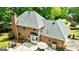 Brick house with a chimney, back patio area, and a well-maintained green roof at 255 Emerald Lake Dr, Fayetteville, GA 30215
