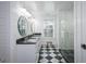 Stylish bathroom featuring dual sinks, glass shower, modern fixtures, and a checkered floor pattern at 211 Hogan Coweta Rd, Hogansville, GA 30230