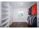 Organized walk-in closet with built-in shelving and hanging rods for ample storage at 211 Hogan Coweta Rd, Hogansville, GA 30230