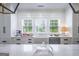 Bright kitchen featuring a large farmhouse sink, stainless steel appliances, and a large window at 211 Hogan Coweta Rd, Hogansville, GA 30230