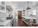 Bright kitchen featuring a spacious island, stainless steel appliances, and modern lighting fixtures at 211 Hogan Coweta Rd, Hogansville, GA 30230