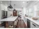 Stylish kitchen with a center island, farmhouse sink, and stainless steel appliances at 211 Hogan Coweta Rd, Hogansville, GA 30230