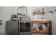 Well-appointed laundry room featuring a farmhouse sink and modern washer and dryer set at 211 Hogan Coweta Rd, Hogansville, GA 30230