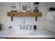 Laundry room sink featuring rustic wood shelf and farmhouse style decor at 211 Hogan Coweta Rd, Hogansville, GA 30230
