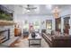 Cozy living room with a stone fireplace, leather sofa, and a sliding barn door at 211 Hogan Coweta Rd, Hogansville, GA 30230