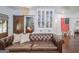 Cozy living room with a leather sofa, built in cabinets, and a view into a bedroom at 211 Hogan Coweta Rd, Hogansville, GA 30230
