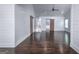 Bright living area featuring hardwood floors, barn doors, and white shiplap walls at 211 Hogan Coweta Rd, Hogansville, GA 30230