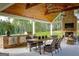 Well-appointed outdoor patio with a built-in grill, fireplace, and dining area at 211 Hogan Coweta Rd, Hogansville, GA 30230