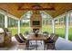 Inviting outdoor patio with fireplace, dining table, and comfortable seating at 211 Hogan Coweta Rd, Hogansville, GA 30230