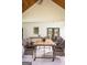 Inviting outdoor seating area with a table and chairs set on a covered patio with bright overhead lighting at 211 Hogan Coweta Rd, Hogansville, GA 30230