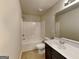 Bathroom features a shower-tub combination, modern sink and vanity, with tile flooring at 1392 Worcester Trl, Mcdonough, GA 30253