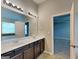 Bathroom features a double sink vanity with granite countertop and ample lighting at 1392 Worcester Trl, Mcdonough, GA 30253