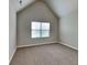 Cozy bedroom with carpet, vaulted ceiling, and window offering natural light at 1392 Worcester Trl, Mcdonough, GA 30253