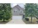 Charming two-story home with gray siding, a two-car garage, and a well-maintained front yard at 1392 Worcester Trl, Mcdonough, GA 30253