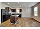 Modern kitchen with granite countertops, stainless steel appliances, and a center island at 1392 Worcester Trl, Mcdonough, GA 30253