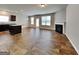 Open living space with hardwood floors, fireplace, and access to the kitchen at 1392 Worcester Trl, Mcdonough, GA 30253