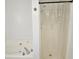 Bathroom featuring a bathtub, a shower with curtain, and clean, bright fixtures at 10 Nicole Ct, Covington, GA 30016