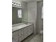 Bathroom with double sinks, vanity, and toilet, offering a bright and functional space at 10 Nicole Ct, Covington, GA 30016