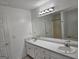 Bathroom featuring double sinks, vanity, and a large mirror, offering plenty of space at 10 Nicole Ct, Covington, GA 30016