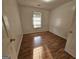 Bedroom with wood look flooring and a window at 10 Nicole Ct, Covington, GA 30016