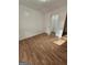 Bedroom featuring a closet, wood look flooring and white walls at 10 Nicole Ct, Covington, GA 30016