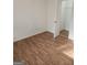 Bedroom featuring a closet, wood look flooring and white walls at 10 Nicole Ct, Covington, GA 30016