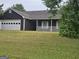 Traditional one-story home with a spacious front yard, garage, and covered porch at 10 Nicole Ct, Covington, GA 30016
