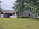 Traditional one-story home with a well-maintained lawn, garage, and covered porch at 10 Nicole Ct, Covington, GA 30016