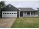 Charming one-story home with a spacious two-car garage and inviting front porch at 10 Nicole Ct, Covington, GA 30016