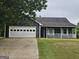 Charming one-story home with a spacious two-car garage and inviting front porch at 10 Nicole Ct, Covington, GA 30016