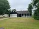 Charming single-story home with a two-car garage, spacious lawn, and white picket fence in front at 10 Nicole Ct, Covington, GA 30016