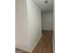 Hallway with wood-look floors and white walls at 10 Nicole Ct, Covington, GA 30016