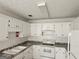 Bright kitchen with white cabinets, marbled countertops, and white appliances at 10 Nicole Ct, Covington, GA 30016