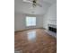 Living room featuring hardwood floors, fireplace, and a ceiling fan at 10 Nicole Ct, Covington, GA 30016
