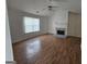 Living room featuring hardwood floors, fireplace, and a ceiling fan at 10 Nicole Ct, Covington, GA 30016