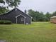 Spacious backyard with a storage building, showing the rear of the house at 10 Nicole Ct, Covington, GA 30016