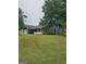 View of the home with a big backyard, featuring a storage building at 10 Nicole Ct, Covington, GA 30016