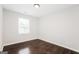 A sunlit bedroom with hardwood floors and a large window at 1590 Sw Cherry Hill Ln, Conyers, GA 30094