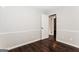 A cozy bedroom features neutral walls, wood floors, and natural light at 1590 Sw Cherry Hill Ln, Conyers, GA 30094