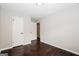 An inviting bedroom boasts neutral walls and stunning wood floors at 1590 Sw Cherry Hill Ln, Conyers, GA 30094