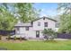 A charming two-story home with a deck, a well-kept lawn, and mature landscaping at 1590 Sw Cherry Hill Ln, Conyers, GA 30094
