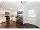 Modern kitchen with white cabinets, stainless steel appliances, granite countertops, and dark hardwood floors at 1590 Sw Cherry Hill Ln, Conyers, GA 30094